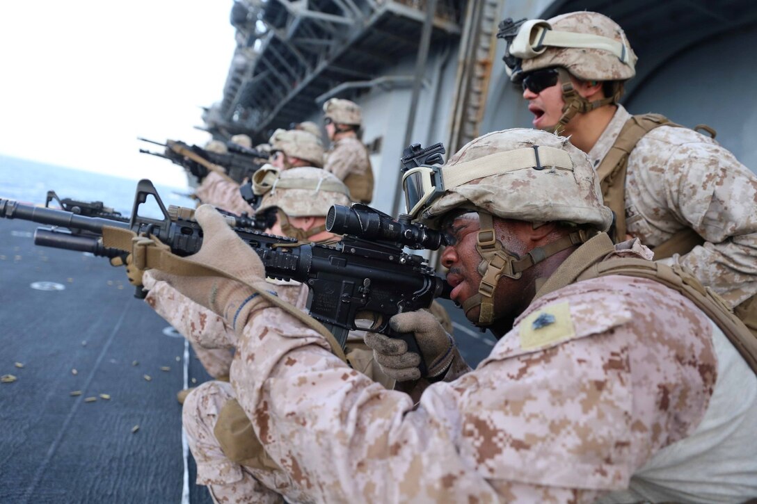 Sgt. Keenan Rheaves, a platoon sergeant with Golf Company, Battalion Landing Team 2nd Battalion, 1st Marines, 11th Marine Expeditionary Unit (MEU), sites in on his practice target aboard amphibious assault ship USS Makin Island (LHD 8), Nov. 8. The Makin Island Amphibious Ready Group (ARG) and the embarked 11th MEU are deployed in support of maritime security operations and theater security cooperation efforts in the U.S. 5th Fleet area of responsibility. (U.S. Marine Corps photos by Cpl. Demetrius Morgan/ Released)    