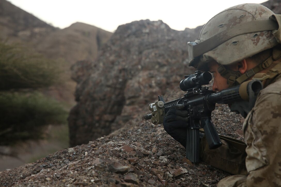 U.S. Marine Corps Cpl. David S. Chandler, a light armored vehicle crewman with Charlie Company, 1st Light Armored Reconnaissance detachment, Battalion Landing Team 2nd Battalion, 1st Marines, 11th Marine Expeditionary Unit (MEU), and native of Dublin, California, looks through the optic on his M4 carbine while providing security from an over watch position during a security patrol as part of sustainment training in D'Arta Plage, Djibouti, Nov. 6. The 11th MEU is deployed to maintain regional security in the U.S. 5th Fleet area of responsibility. (U.S. Marine Corps photo by Cpl. Jonathan R. Waldman/Released)