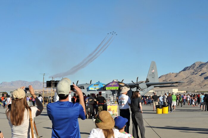 Spectators at the Nellis Open House snap photos of the F-16 Fighting Falcons of the U.S. Air Force Aerial Demonstration Squadron, the Thunderbirds, at Nellis Air Force Base, Nev., Nov. 9, 2014. More than 176,000 people attended the Nellis Open House this year. (U.S. Air Force photo by Tech. Sgt. Sanjay Allen)