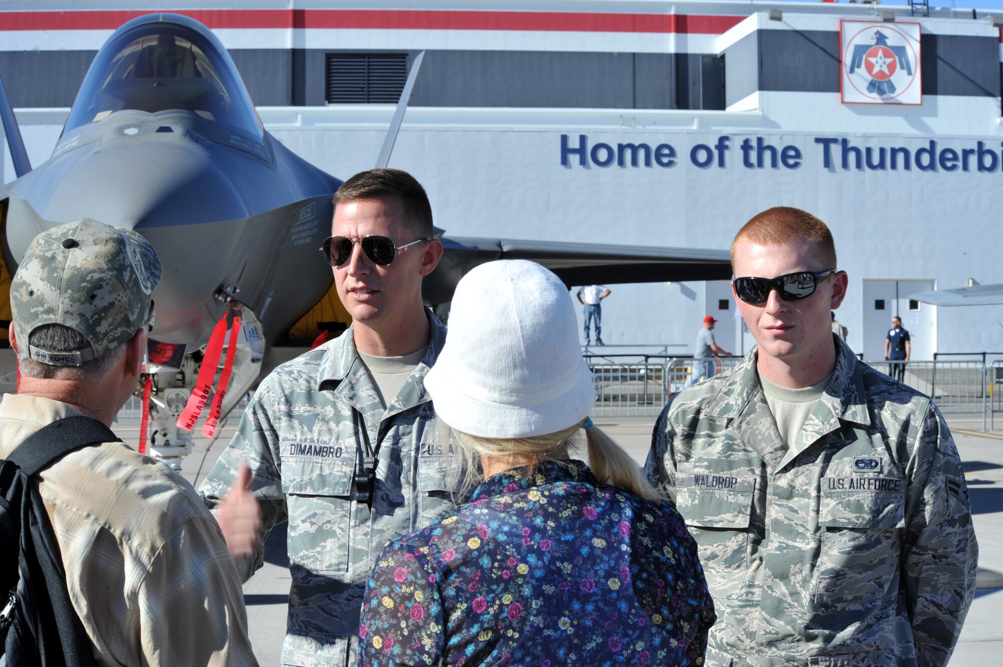 Staff Sgt. Nathan Dimambro and Airman 1st Class Dustin Waldrop, both members of the 57th Aircraft Maintenance Squadron, explain the features of the F-35A Lightning II to visitors attending the Nellis Open House at Nellis Air Force Base, Nev., Nov. 9, 2014. The F-35 is the U.S. Air Force’s latest fifth generation fighter. It will replace the U.S. Air Force’s aging fleet of F-16 Fighting Falcons and A-10 Thunderbolt II’s, which have been the primary fighter aircraft for more than 20 years, and bring with it an enhanced capability to survive in the advanced threat environment in which it was designed to operate. (U.S. Air Force photo by Tech. Sgt. Sanjay Allen)