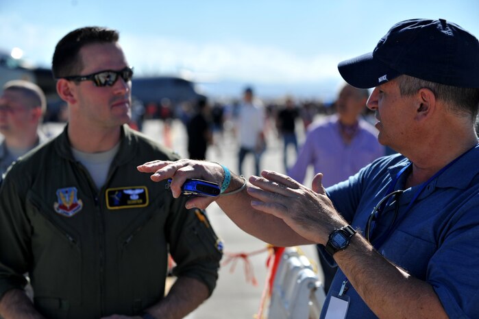 A visitor to the Nellis Open House speaks to 1st Lt. Erick Williams, 963rd Airborne Air Control Squadron, Tinker Air Force Base, Okla., at Nellis Air Force Base, Nev., Nov. 9, 2014. Williams is a copilot on the E-3 Sentry, which is an airborne warning and control system, or AWACS, aircraft that provides an accurate, real-time picture of the battlespace to the Joint Air Operations Center. (U.S. Air Force photo by Tech. Sgt. Sanjay Allen)