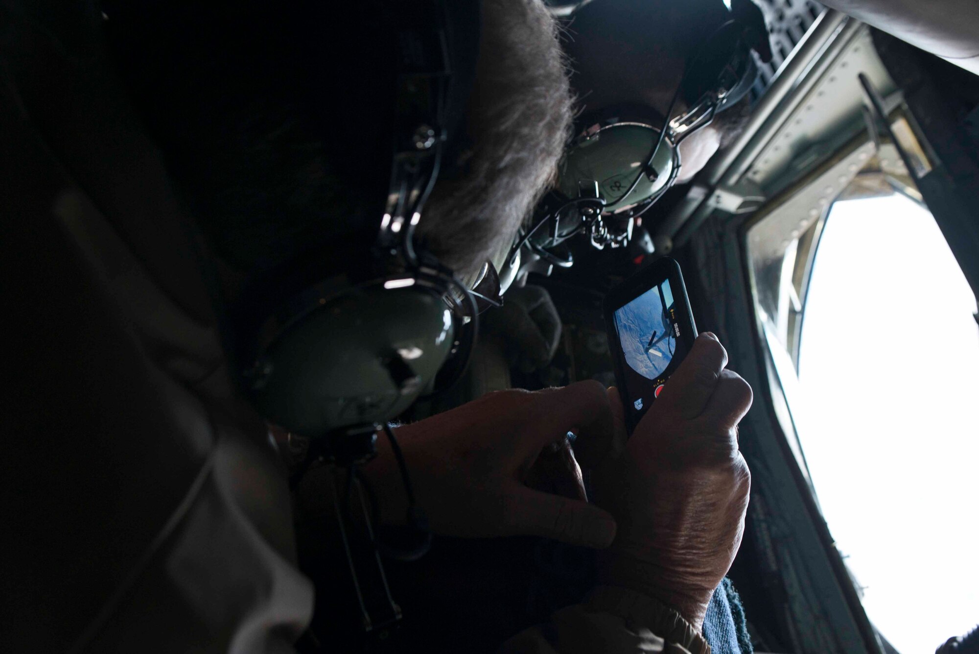 Joel Fenwick, a Fairchild honorary commander, records an approaching F-15E Strike Eagle during an incentive inflight refueling mission over Nevada airspace Nov. 6, 2014.  The training mission was an opportunity for community members to experience Fairchild’s mission first hand. (U.S. Air Force photo/Staff Sgt. Alexandre Montes)