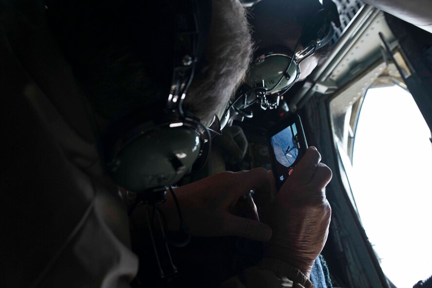 Loel Fenwick, a Fairchild honorary commander, records an approaching F-15E Strike Eagle during an incentive inflight refueling mission over Nevada airspace Nov. 6, 2014. The training mission was an opportunity for community members to experience Fairchild’s mission first hand. (U.S. Air Force photo/Staff Sgt. Alexandre Montes)