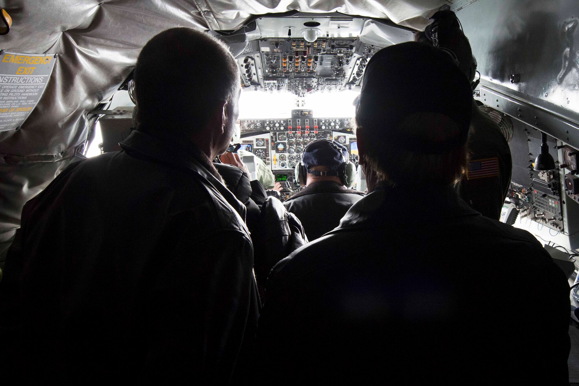 Fairchild honorary commanders watch as pilots Capt. Andrea May and Capt. Trenton Palmer, 92nd Operations Support Squadron, communicate with approaching aircraft for inflight refueling over Nevada airspace Nov. 6, 2014. The honorary commanders program pairs Spokane Civic Leaders with personnel at Fairchild to form a bond and familiarize the community with Fairchild operations fostering mutual understanding and establishing long lasting bonds of friendship. (U.S. Air Force photo/Staff Sgt. Alexandre Montes)