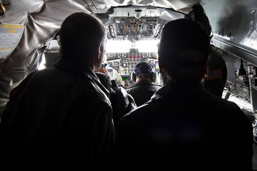 Fairchild honorary commanders watch as pilots Capt. Andrea May and Capt. Trenton Palmer, 92nd Operations Support Squadron, communicate with approaching aircraft for inflight refueling over Nevada airspace Nov. 6, 2014. The honorary commanders program pairs Spokane Civic Leaders with personnel at Fairchild to form a bond and familiarize the community with Fairchild operations fostering mutual understanding and establishing long lasting bonds of friendship. (U.S. Air Force photo/Staff Sgt. Alexandre Montes)