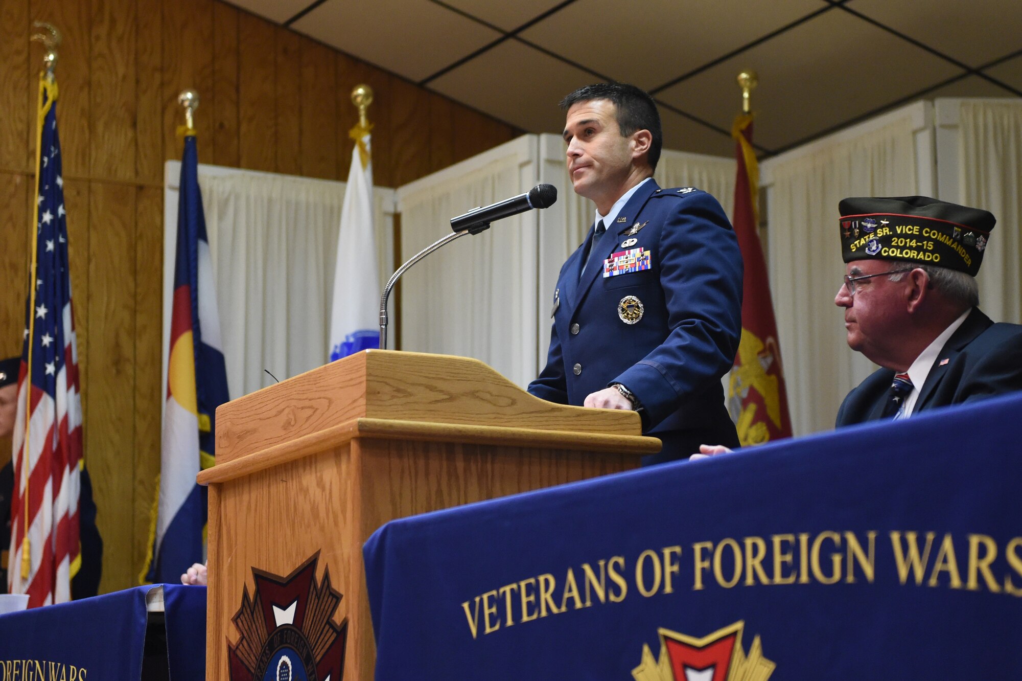 Col. John Wagner, 460th Space Wing commander, delivers the keynote speech during the 37th annual Fort Logan National Cemetery Veterans Day remembrance service Nov. 11, 2014, in Englewood, Colo. The observance, moved to Veterans of Foreign Wars Post 9644 due to inclement weather, included several guest speakers, patriotic music and a wreath ceremony in honor of fallen service members. (U.S. Air Force photo by 1st Lt. Trevor Zakrzewski/Released)