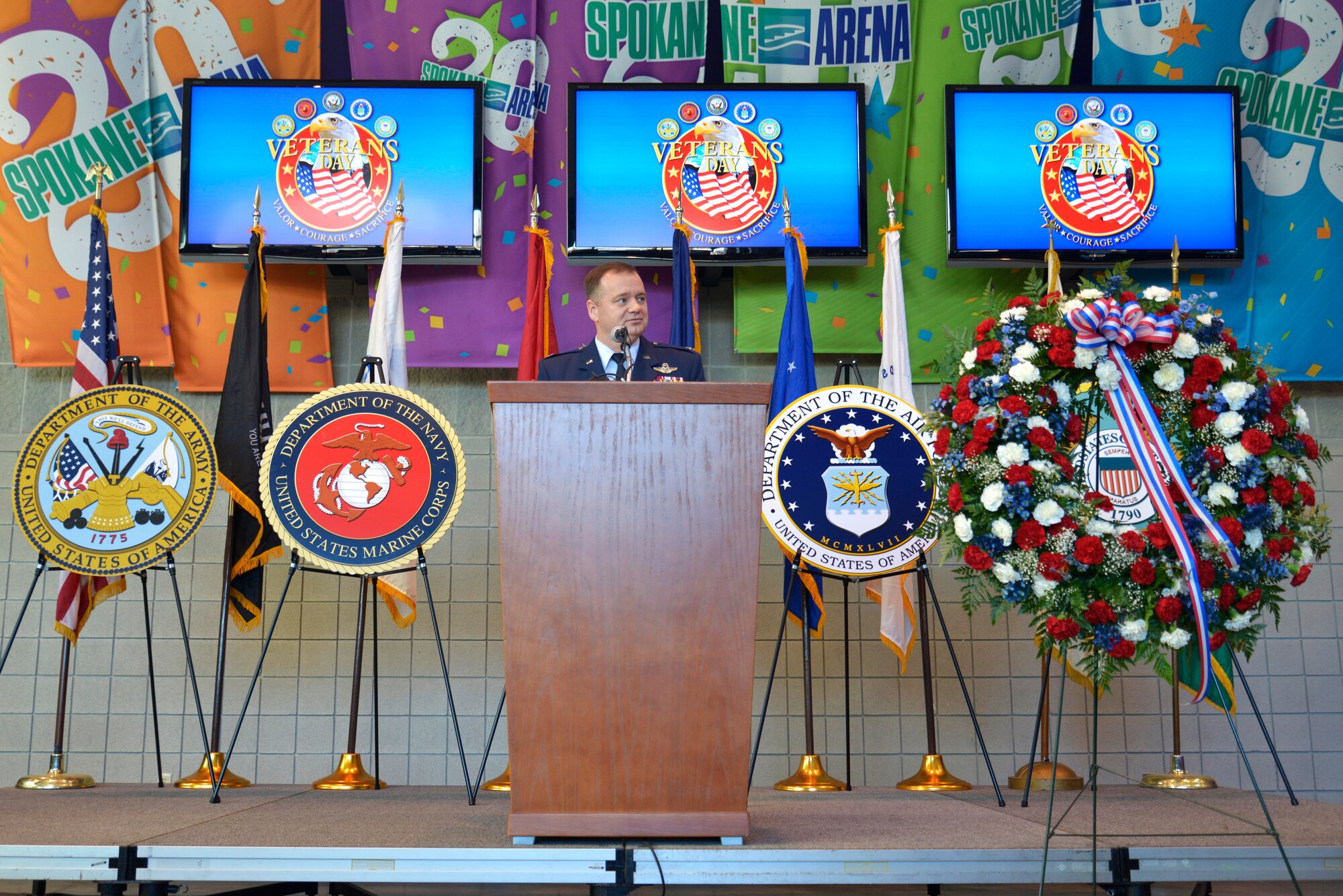 Col. Brian McDaniel, the 92nd Air Refueling Wing commander, speaks to the Spokane community during a Veterans Day ceremony  Nov. 11, 2014, at the Spokane Veterans Memorial Arena in Spokane, Wash. The purpose of Veterans Day is to honor America's veterans for their patriotism, love of country, willingness to serve and sacrifice for the common good. Fairchild Airmen visited several locations Nov. 11 to show appreciation and interact with veterans. (U.S. Air Force photo/Airman 1st Class Janelle Patiño)