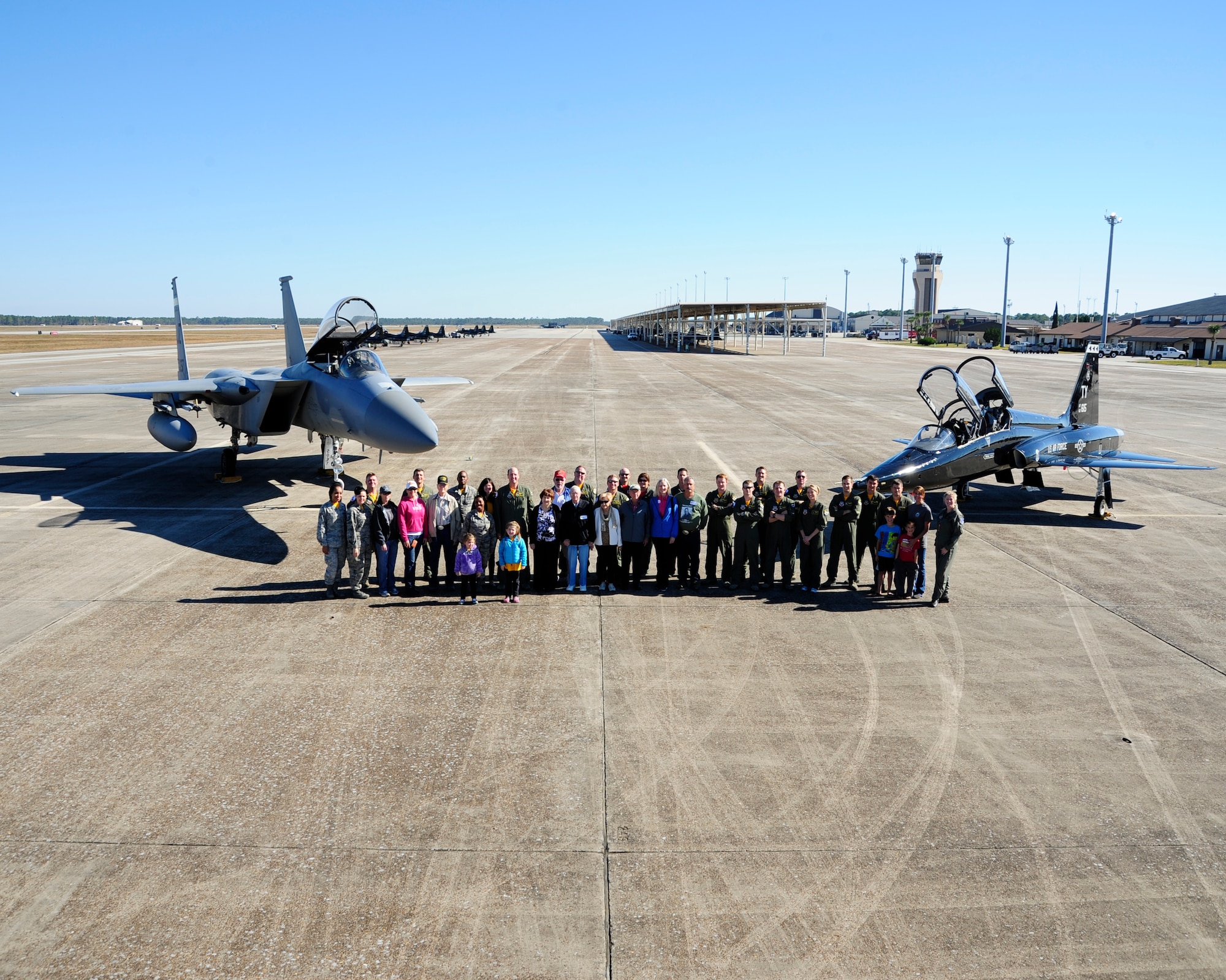 American Beagle Squadron veterans and members of the 2nd Fighter Training Squadron pose for a group photo during a tour of the flight line on Nov. 2. at Tyndall Air Force base. The reunion was the first one since the 2nd Fighter Training Squadron was reactivated in 2012. (U.S. Air Force photo by Airman 1st Class Solomon Cook)