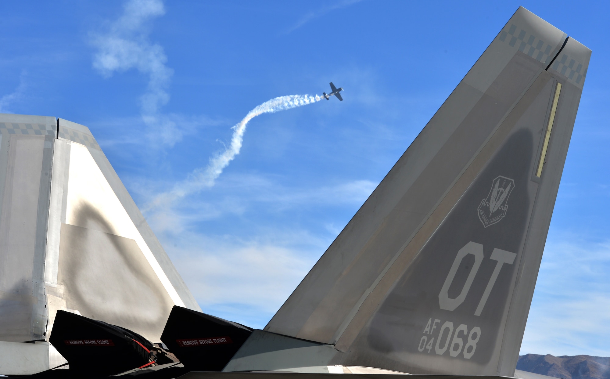An AT-6 Texan aircraft performs during a legacy bomber aerial demonstration at the Nellis Air Force Base 2014 Open House on Nellis AFB, Nevada, Nov. 9, 2014. The two-day event includes aerial demonstration from a variety of legacy bomber aircraft, a Korean Conflict reenactment, and a United States Air Force Aerial Demonstration Team Thunderbirds performance. (U.S. Air Force photo by Tech. Sgt. Nadine Barclay)