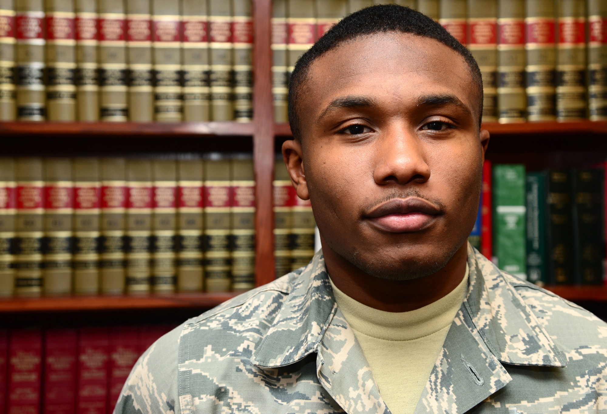 VANCE AIR FORCE BASE, Okla. -- Airman 1st Class Graham Davis, a 71st Flying Training Wing Judge Advocate Office paralegal, stands in front of legal reference books in his office, Nov. 10. Davis is the 71st FTW Airman of the Month for October. (U.S. Air Force photo/Senior Airman Frank Casciotta)