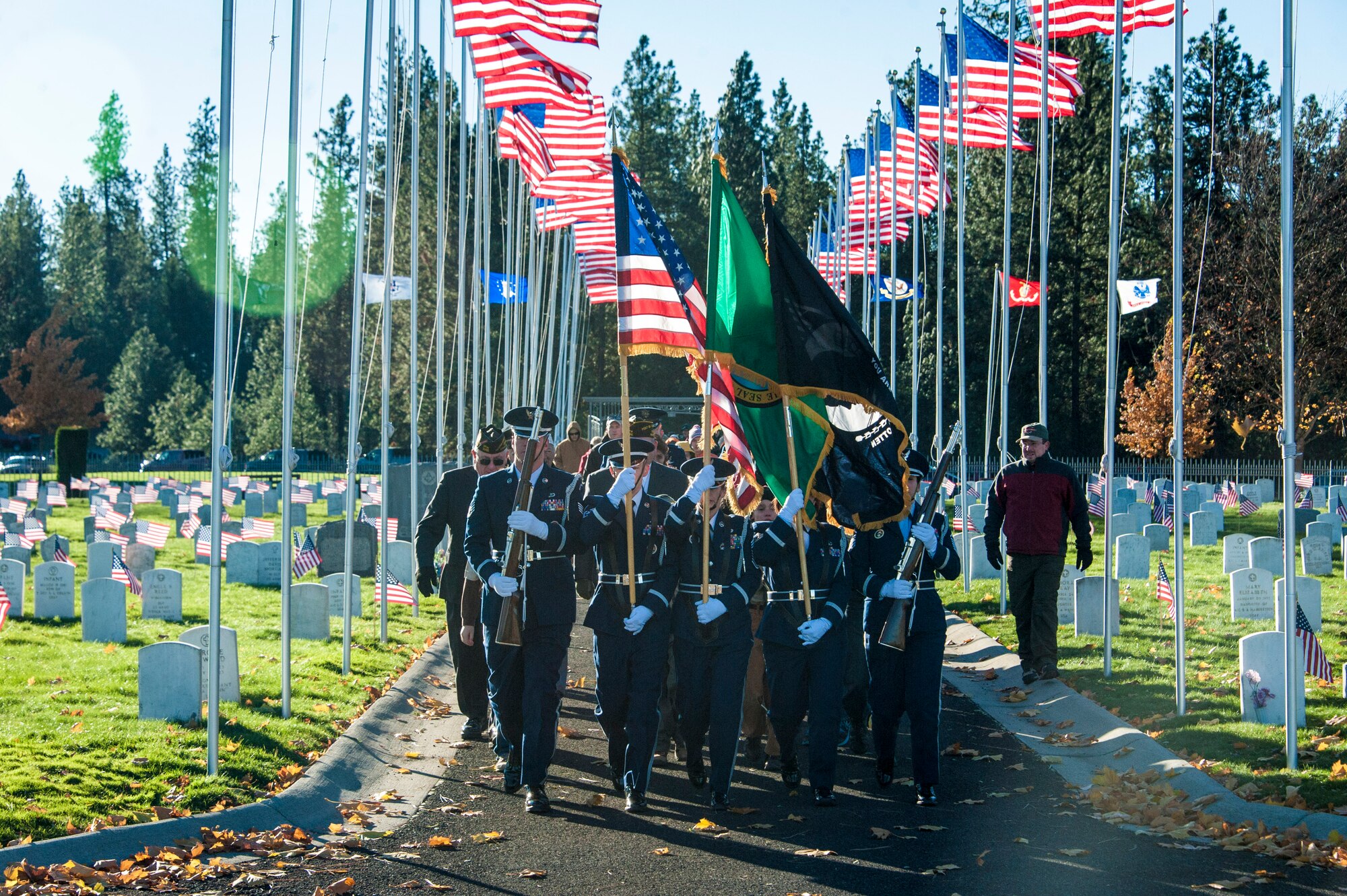 Fairchild Air Force Base’s Honor Guard flanked by Airway Heights’ Veterans of Foreign Wars Post 3386 and Fairchild’s Boy Scout Troop 342 lead the procession of service and community members alike during a Veterans Day ceremony at Fort George Wright Veterans Cemetery, Nov. 11, 2014, in Spokane, Wash. Since its inception on May 13, 1938, Veterans Day continues to be observed on November 11, regardless of what day of week it falls. (U.S. Air Force photo/Staff Sgt. Benjamin W. Stratton)