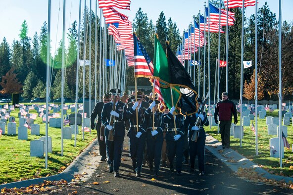 Fairchild Air Force Base’s Honor Guard flanked by Airway Heights’ Veterans of Foreign Wars Post 3386 and Fairchild’s Boy Scout Troop 342 lead the procession of service and community members alike during a Veterans Day ceremony at Fort George Wright Veterans Cemetery, Nov. 11, 2014, in Spokane, Wash. Since its inception on May 13, 1938, Veterans Day continues to be observed on November 11, regardless of what day of week it falls. (U.S. Air Force photo/Staff Sgt. Benjamin W. Stratton)