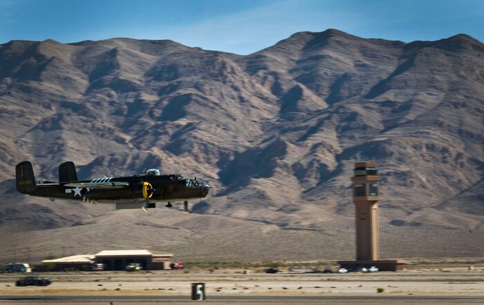 A B-25J Mitchell takes flight during the open house at Nellis Air Force Base, Nev., Nov. 9, 2014. The B-25 was one of the most heavily armed airplanes in the world and was used for high- and low-level bombing, strafing, photo-reconnaissance, submarine patrol, as a fighter, and was distinguished as the aircraft that completed the historic raid over Tokyo in 1942. (U.S. Air Force photo by Airman 1st Class Rachel Loftis) 