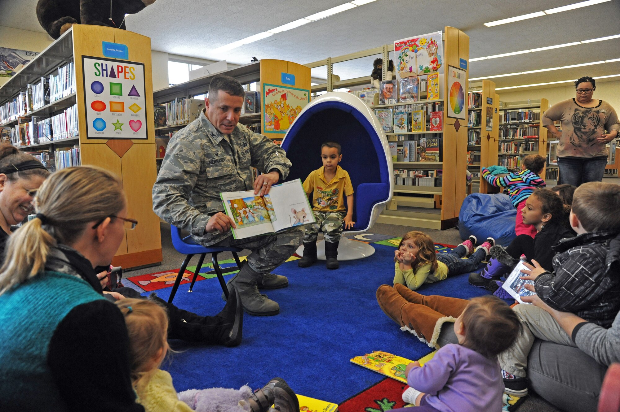 Col. Anthony Hernandez, 319th Mission Support Group commander, reads the book "If You Give a Mouse a Cookie" to children at the Library on Grand Forks Air Force Base, N.D., Nov. 12, 2014. The library hosts weekly storytime and craft sessions for young children. (U.S. Air Force photo/Staff Sgt. David Dobrydney)