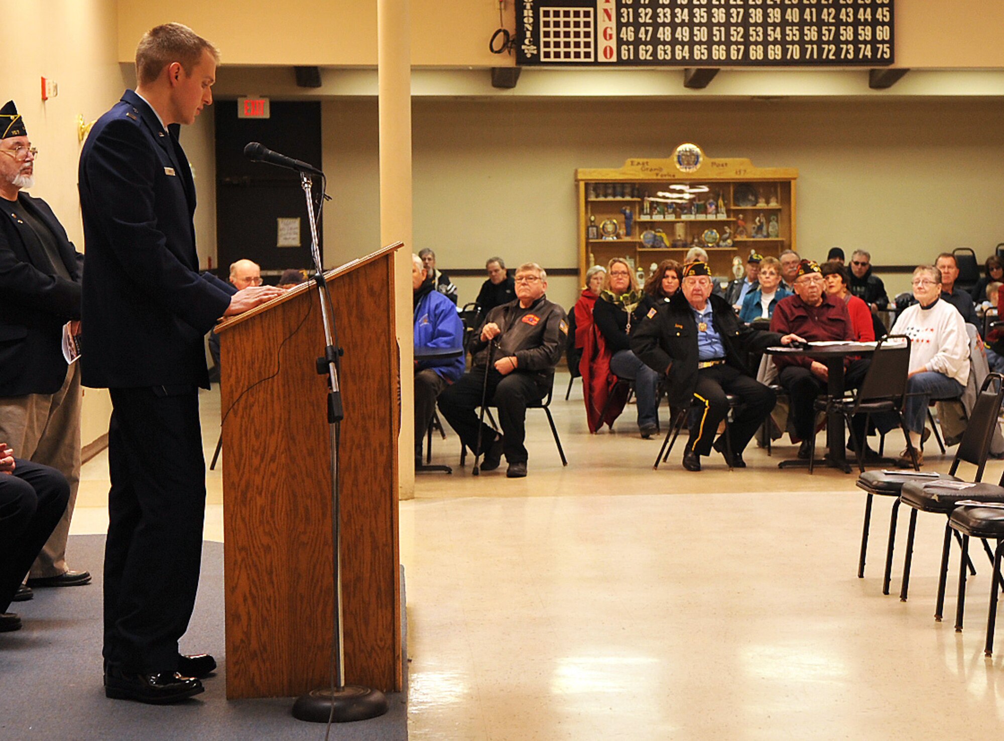 Capt. Bradley Davies, 69th Reconnaissance Group commander’s action group director, gives a Veterans Day speech for members of the community at the American Legion in East Grand Forks, Minn. Nov. 11, 2014. There were 67 people in attendance including veterans and their families. This was one of seven locations that Grand Forks Airmen visited in order to reach out to surrounding communities. (U.S. Air Force photo/Airman 1st Class Bonnie Grantham)