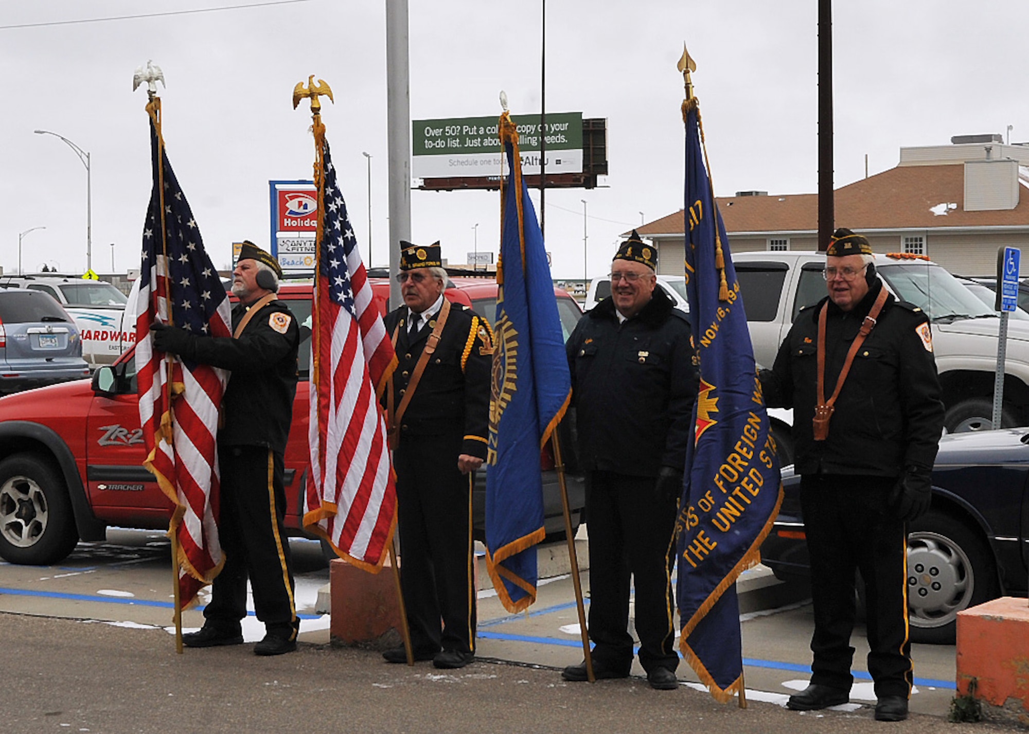 Members of the American Legion Post 157 Honor Guard prepare to present their flags during a firing line ceremony in observance of Veterans Day, Nov. 11, 2014, in East Grand Forks, Minn. Airmen from Grand Forks Air Force Base, N.D., traveled to seven different locations ranging from 15 to 60 miles away from the base to give Veterans Day speeches to surrounding communities. (U.S. Air Force photo/Airman 1st Class Bonnie Grantham)