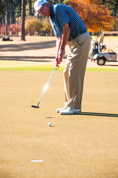 Ken Cooke, a retired Airman, puts the ball in for a par at the Atlanta Athletic Club in John’s Creek, Ga., Nov. 10, 2014. The AAC hosted a Veteran’s Golf Tournament for club members and current servicemembers on their Riverside course, ranked as one of the top private courses by Golf Digest. (U.S. Air Force photo by Senior Airman Daniel Phelps/Released)