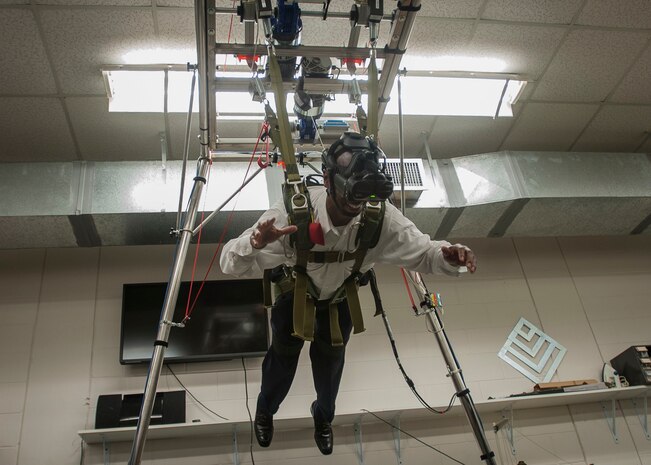 Jamal Middleton, The Midtwon Group president and owner, simulates a parachute jump Nov. 4, 2014, at MacDill Air Force Base, Fla. Joint Base Charleston civic leaders participated in a military tour highlighting the 6th Air Mobility Wing mission. (U.S. Air Force photo / Senior Airman Tom Brading)
