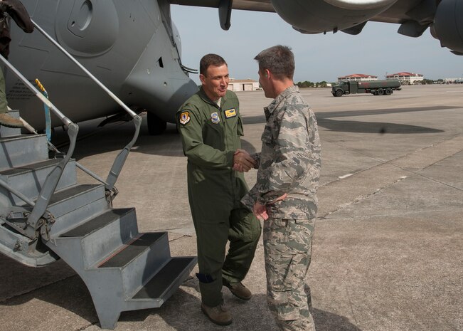Col. Dan Tulley, 6th Mobility Air Wing commander, greets Col. John Lamontagne, 437th Airlift Wing commander, Nov. 4, 2014, at MacDill Air Force Base, Fla. Lamontagne was hosting the Joint Base Charleston Civic Leaders on a tour highlighting the 6th Air Mobility Wing mission at MacDill AFB. (U.S. Air Force photo / Senior Airman Tom Brading)