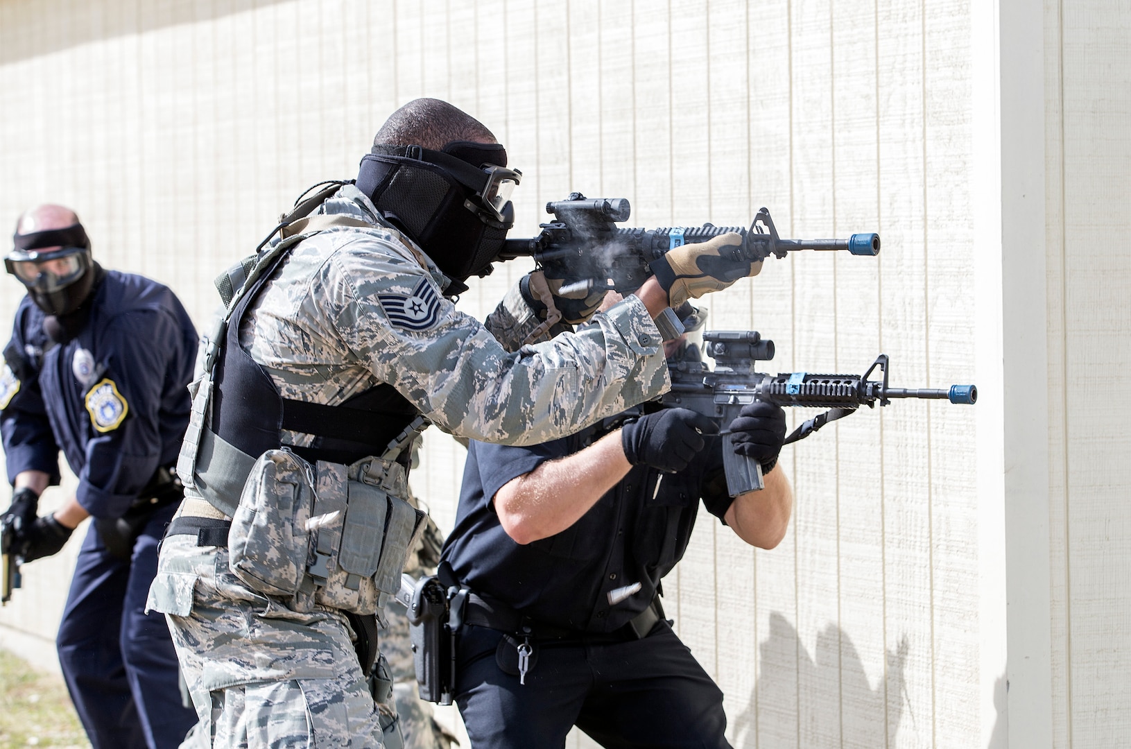 Members of the 902nd Security Forces Squadron fire at hostiles during a barricaded suspect exercise Nov. 10 at Joint Base San Antonio-Randolph’s Camp Talon. Security forces members exchanged simulated munitions fire with hostiles throughout the exercise, bringing more realism while practicing assault force maneuvers during the exercise scenario. (U.S. Air Force photo by Johnny Saldivar)