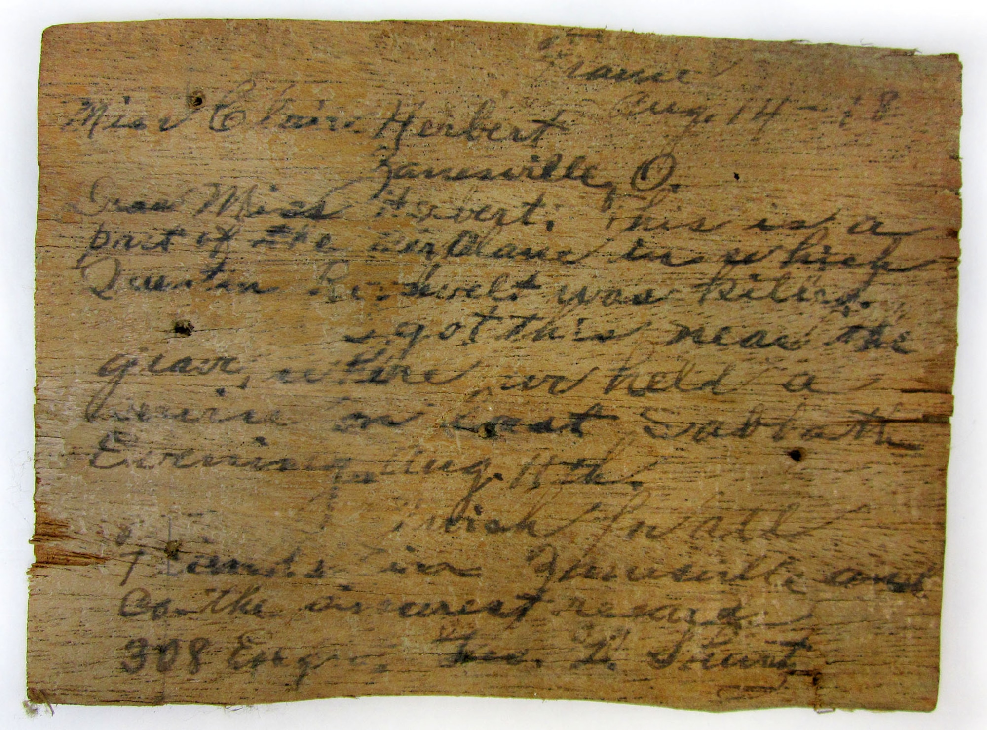 This piece of wood was removed from Lt. Quentin Roosevelt's Nieuport 28 after he was shot down on July 14, 1918. The message on it was written by George G. Shurtz, chaplain of the 308th Engineer Regiment, during World War I. (U.S. Air Force photo)