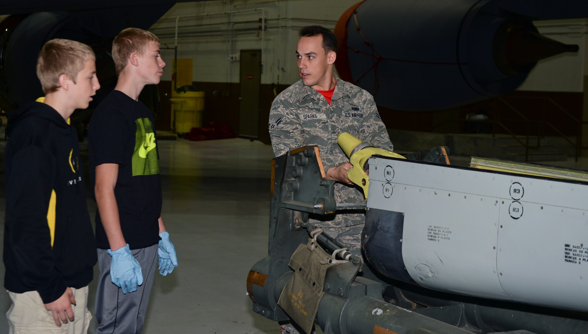 Airman 1st Class Jared Sparks, 22nd Maintenance Squadron hydraulics journeyman, show local area high school students the inside of a boom, Nov. 7, at McConnell Air Force Base, Kan. Sparks explained the importance of each part and how every part of the boom works together. (U.S. Air Force photo/Airman 1st Class Colby L. Hardin)