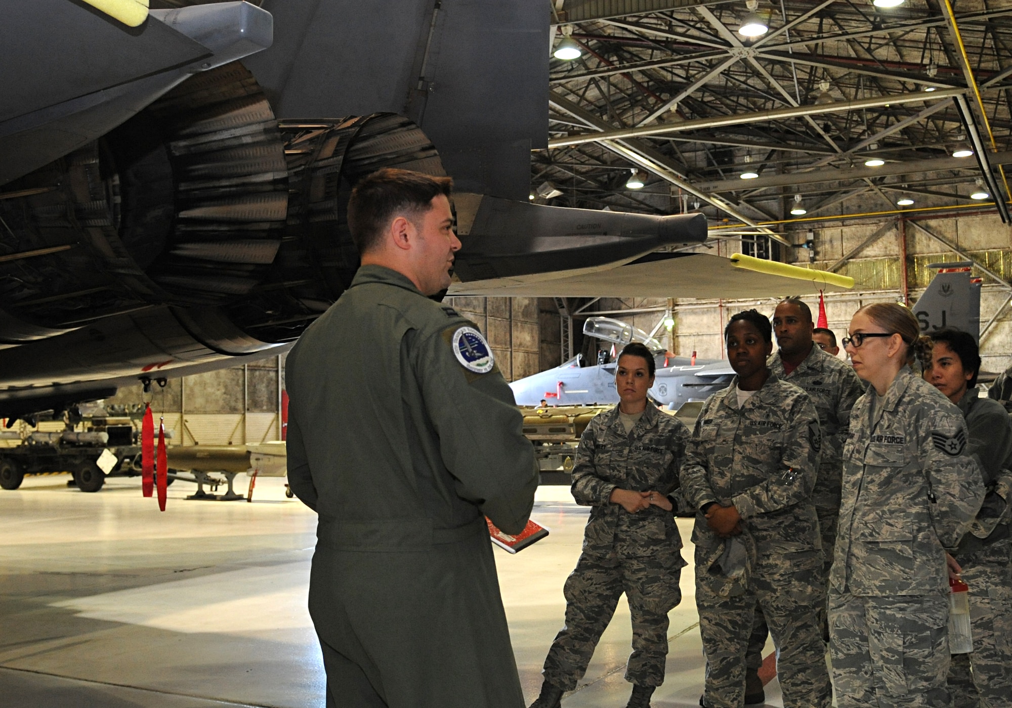 Capt. Christopher Zaremski, 334th Fighter Squadron flight commander, answers questions about the F-15E Strike Eagle during the first 4th Fighter Wing Mission Immersion Day in the weapons load barn at Seymour Johnson Air Force Base, North Carolina, Nov. 7, 2014. Mission Immersion Day participants enjoyed the chance to get up close and personal with the wing’s airframe. The day was designed to give Airmen fulfilling support roles across the base a better understanding of how flying operations are conducted and how their efforts make it possible. (U.S. Air Force photo/Senior Airman Ashley J. Thum)