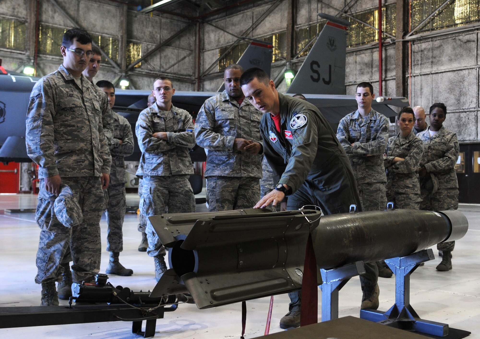 An inert bomb stands on display for the first 4th Fighter Wing Mission Immersion Day in the weapons load barn at Seymour Johnson Air Force Base, North Carolina, Nov. 7, 2014. Airmen on the tour listened to descriptions of each type of munition the F-15E Strike Eagle is capable of carrying. Mission Immersion Day will soon become a monthly event hosted by each fighter squadron in turn. The day was designed to give Airmen fulfilling support roles across the base a better understanding of how flying operations are conducted and how their efforts make it possible. (U.S. Air Force photo/Senior Airman Ashley J. Thum)