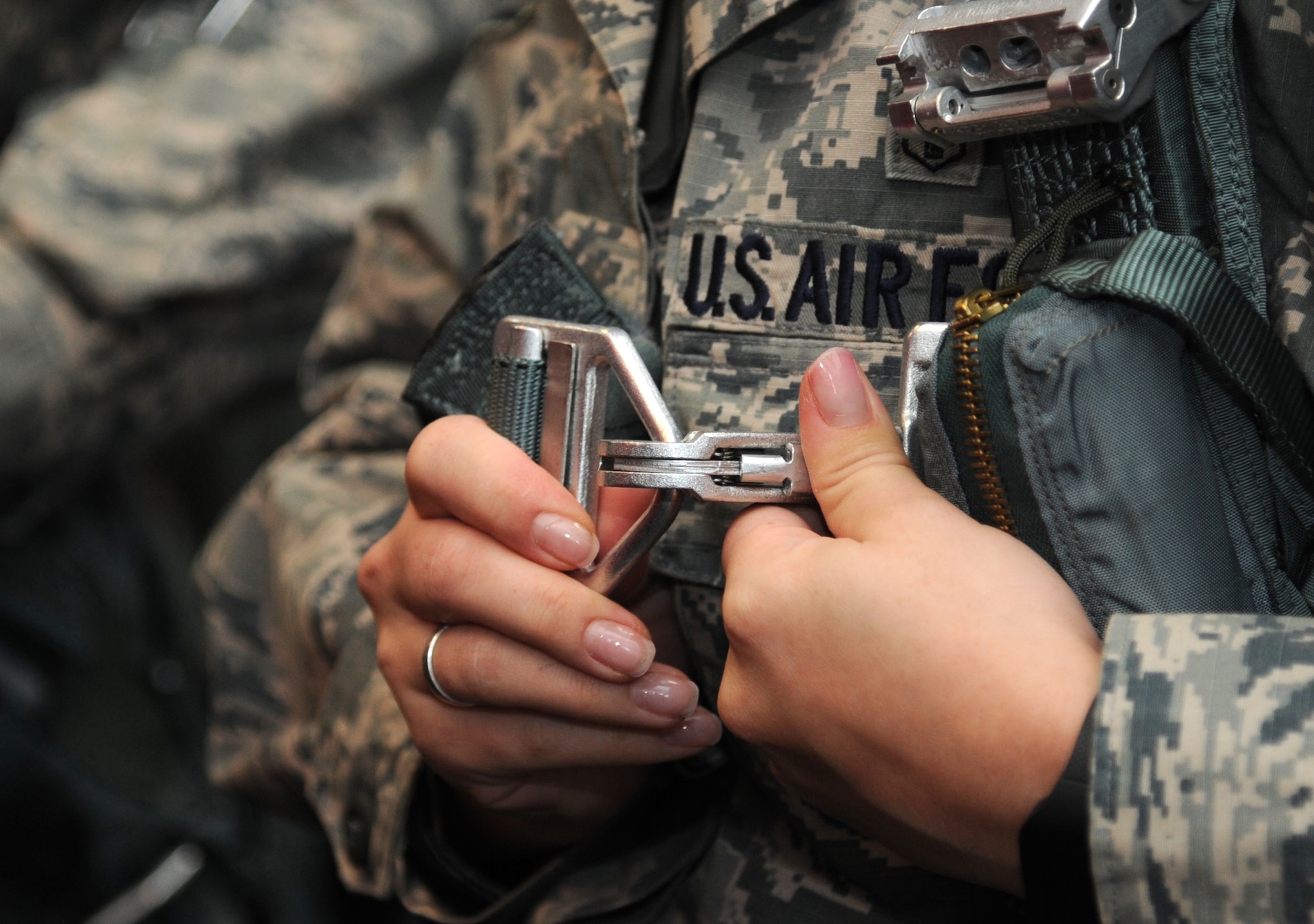 Senior Airman Jessica Bailey, 4th Medical Support Squadron medical logistics technician, secures a torso harness during the first 4th Fighter Wing Mission Immersion Day in the 333rd Fighter Squadron at Seymour Johnson Air Force Base, North Carolina, Nov. 7, 2014. The day offered several glimpses into how flying operations are conducted, including a tour of the air control tower and a static display of an F-15E Strike Eagle. Slated to become a monthly occurrence, the Mission Immersion Day was designed to give Airmen fulfilling support roles across the base a better understanding of how flying operations are conducted and how their efforts make it possible. (U.S. Air Force photo/Senior Airman Ashley J. Thum)