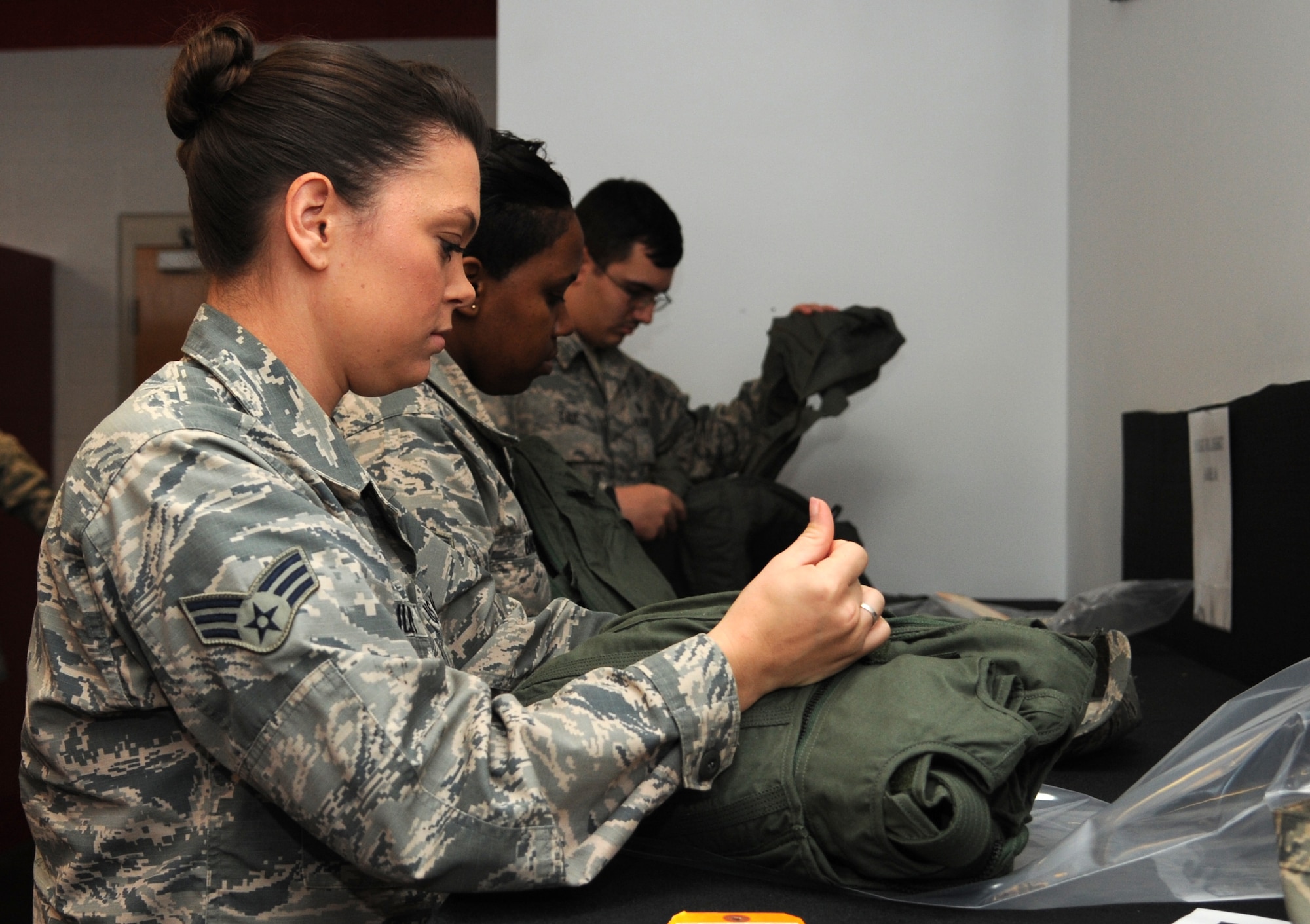 Airmen participating in the first 4th Fighter Wing Mission Immersion Day open aircrew life support equipment at the 333rd Fighter Squadron at Seymour Johnson Air Force Base, North Carolina, Nov. 7, 2014. Several Airmen then donned the equipment to see how aircrews survive in high altitudes. Slated to become a monthly occurrence, the Mission Immersion Day was designed to give Airmen fulfilling support roles across the base a better understanding of how flying operations are conducted and how their efforts make it possible. More than 20 Airmen representing a myriad of squadrons participated in the event, making stops at several operations units. (U.S. Air Force photo/Senior Airman Ashley J. Thum)