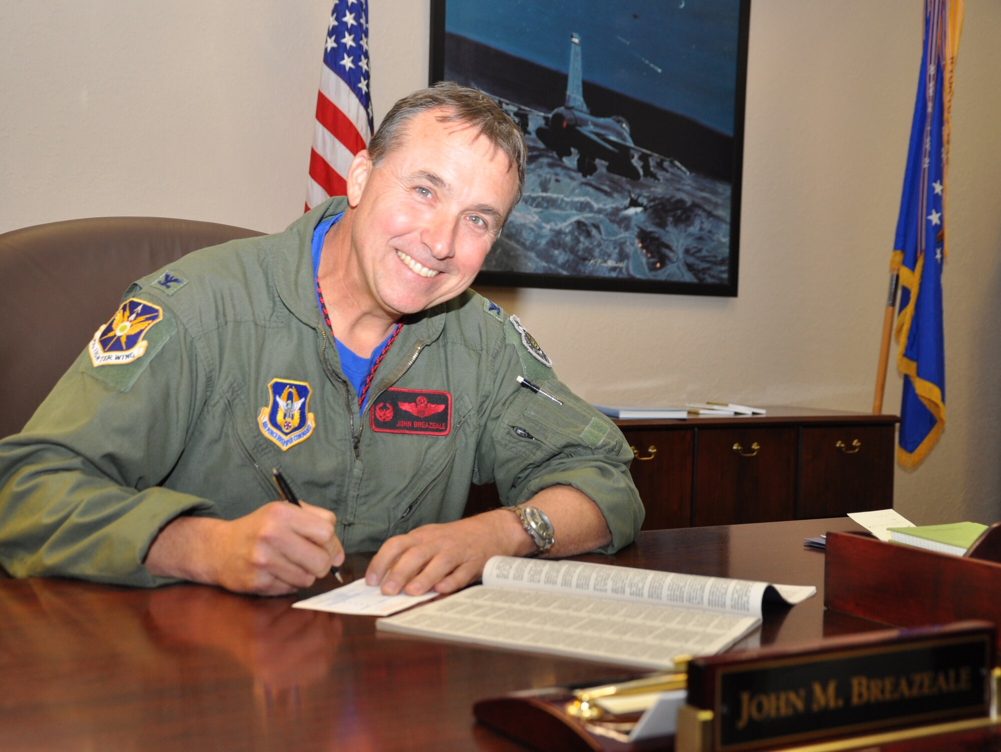 NAVAL AIR STATION FORT WORTH JOINT RESERVE BASE, Texas - Col. John Breazeale, commander of the 301st Fighter Wing here, kicks off the wing's 2014 Combined Federal Campaign by making his charitable contribution Nov. 7. The campaign runs through Dec. 15. CFC is the world's largest and most successful annual workplace charity campaign, with almost 200 CFC campaigns throughout the country and overseas raising millions of dollars each year. (Air Force photo by Darryl Collins)