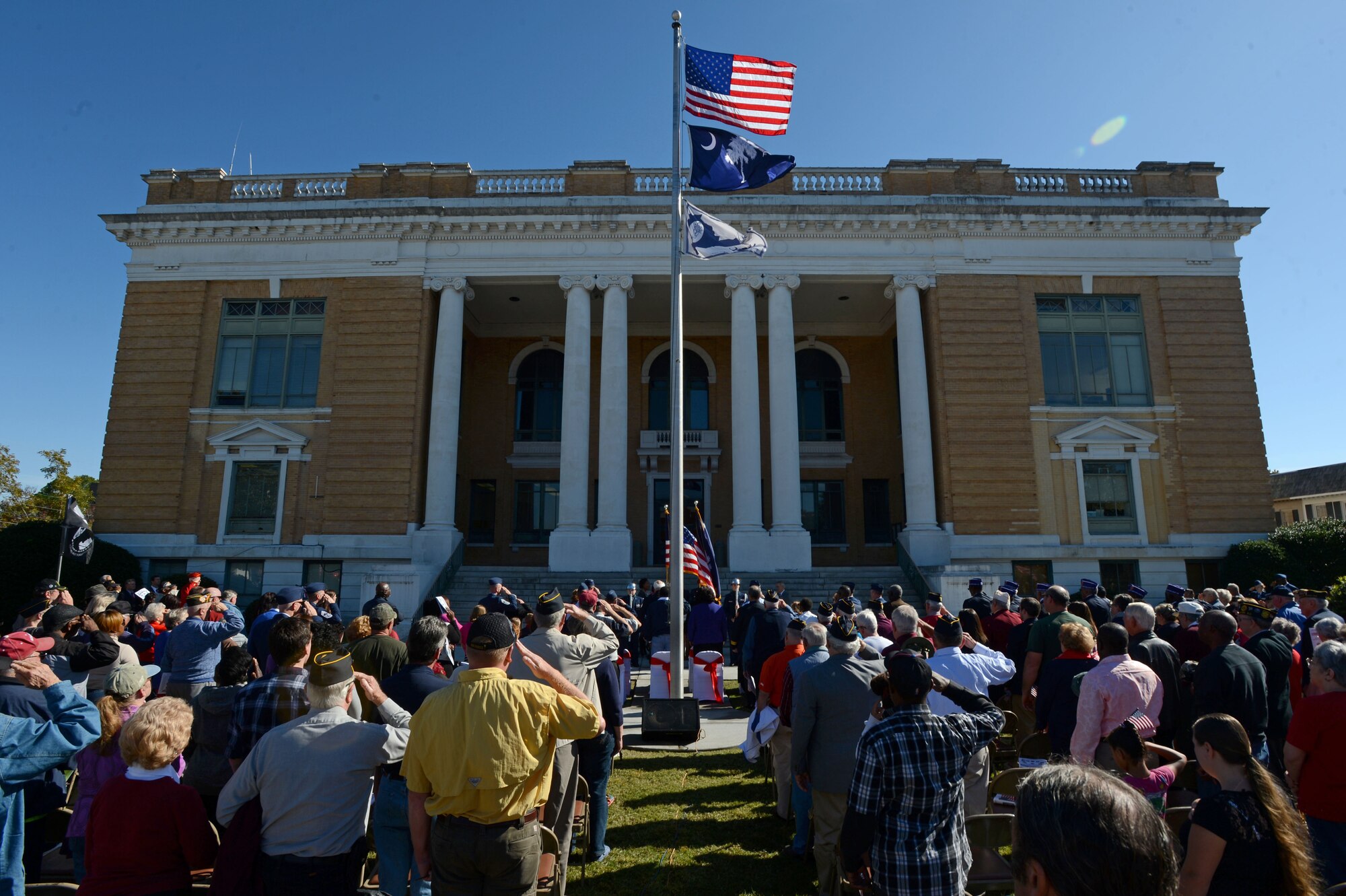 Attendees render salutes at the Veterans Day ceremony at the Sumter County Courthouse, Sumter, S.C., Nov. 11, 2014. More than 400 veterans, their families and local residents attended the event to pay tribute to all Americans who have served in the military. (U.S. Air Force photo by Airman 1st Class Jensen Stidham/Released) 