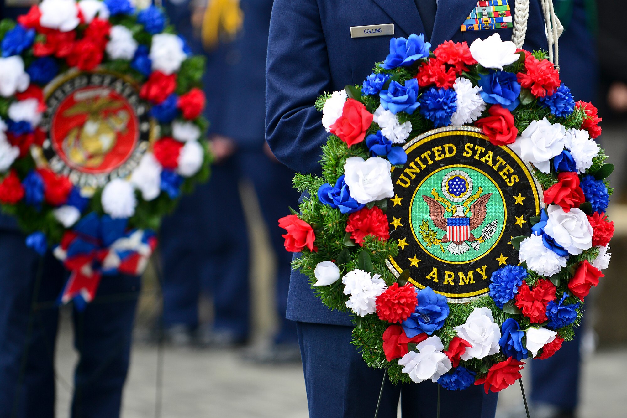 Members of the U.S. Air Force JROTC unit from Menchville High School hold wreaths representing each of the military branches during a Veteran’s Day ceremony at the Victory Arch in Newport News, Va., Nov. 11, 2014. The wreaths were represented to show respect to each of the branches. (U.S. Air Force photo by Senior Airman Kimberly Nagle/Released)