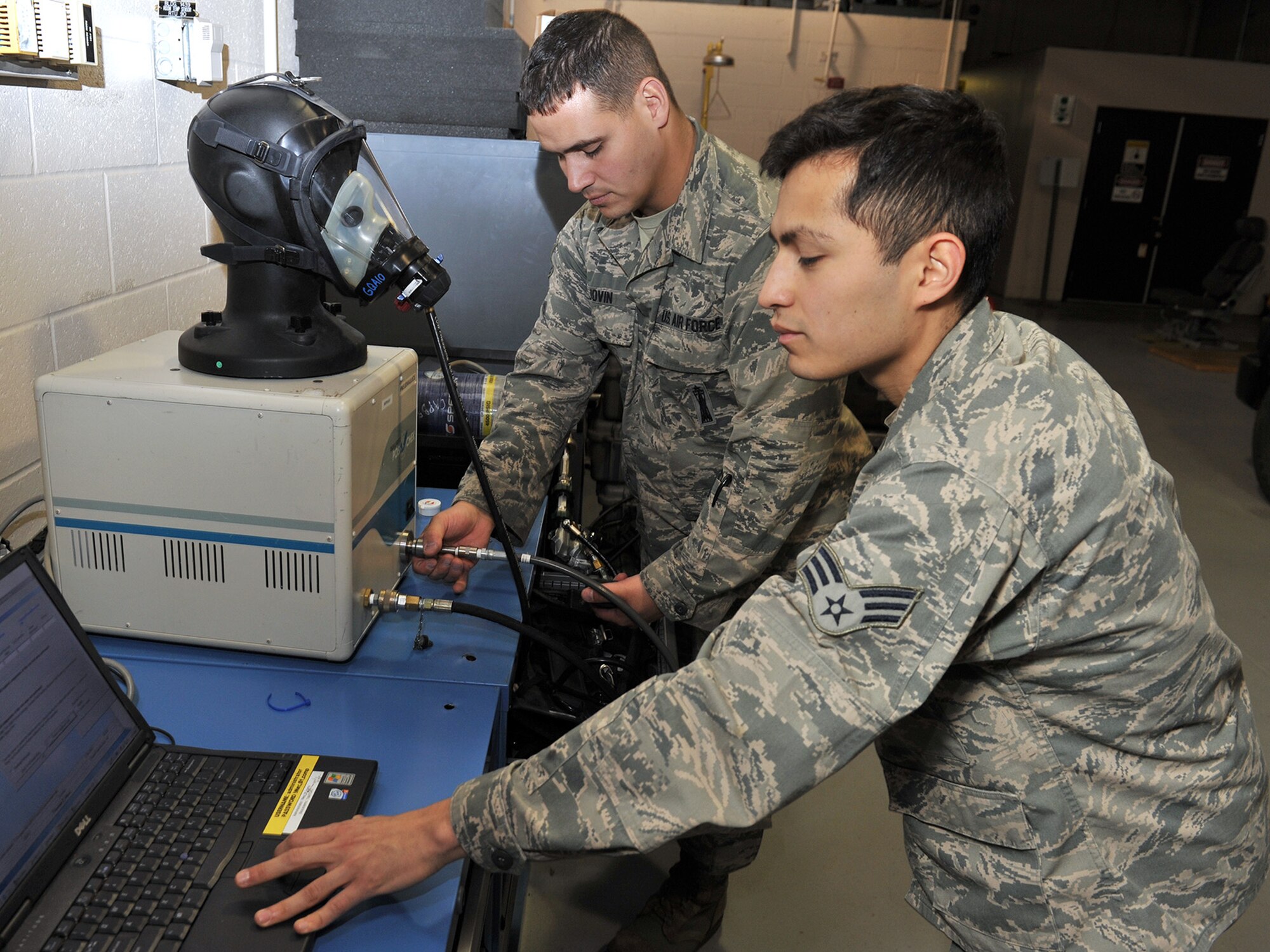 Tech. Sgt. Robert Jovin, 341st Maintenance Group Survivable Systems Team trainer and team chief, and Senior Airman Joe Gonzalez, SST technician, perform periodic inspection on a self-contained breathing apparatus Oct. 31 in their new work center at Bldg. 1439. In addition to SST’s primary task of launch control center maintenance, the shop also supports maintenance teams required to have SCBA units in their trucks when dispatching to missile launch facilities. (U.S. Air Force photo/ John Turner)