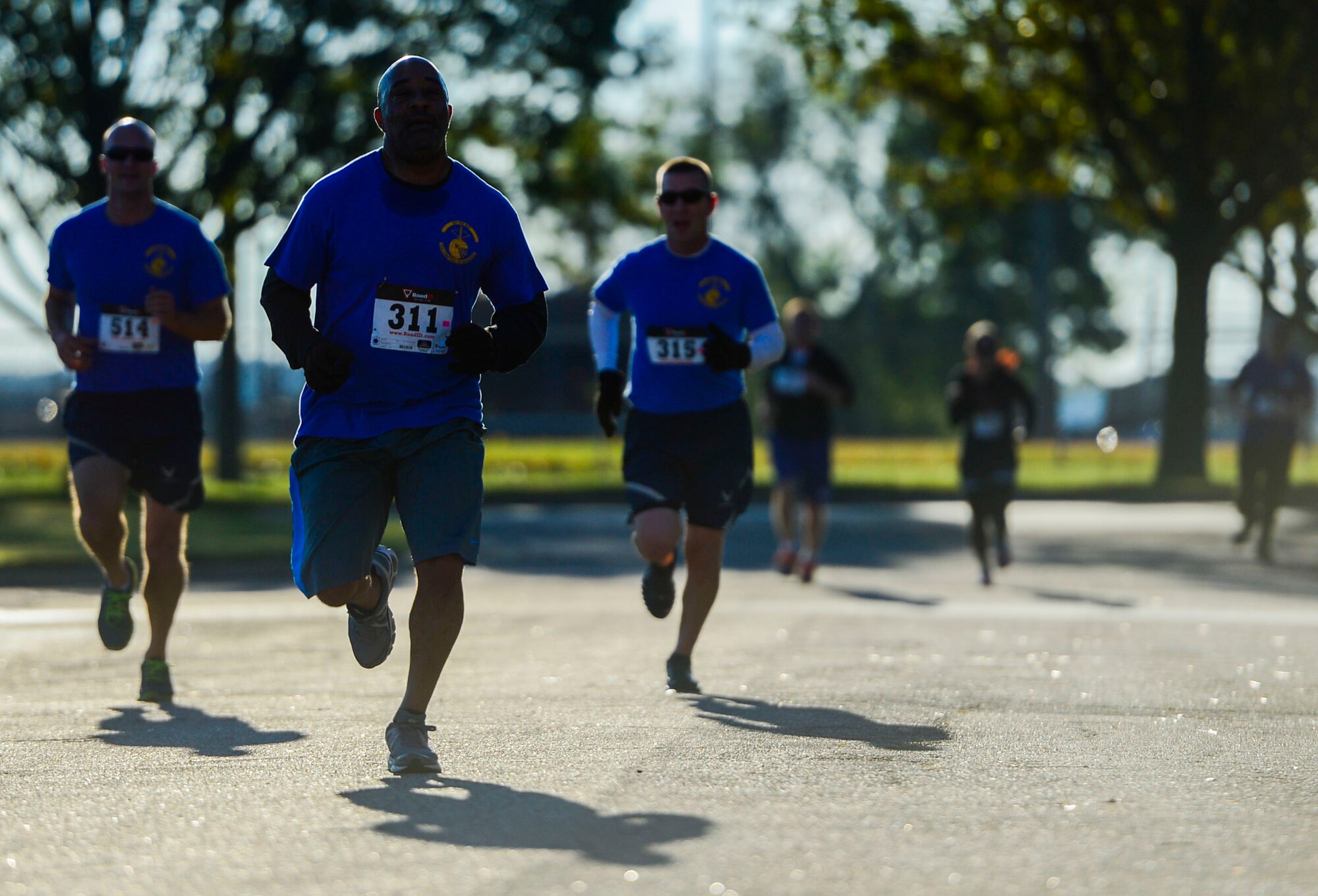Runners participating in the Operation Warmheart 5k food run prepare to cross the finish line at Langley Air Force Base, Va., Nov. 7, 2014. Over the next couple of weeks, Operation Warmheart will be collecting monetary donations as well as canned food donations in order to put together holiday baskets for Service members. (U.S. Air Force photo by Senior Airman Kayla Newman/Released)
