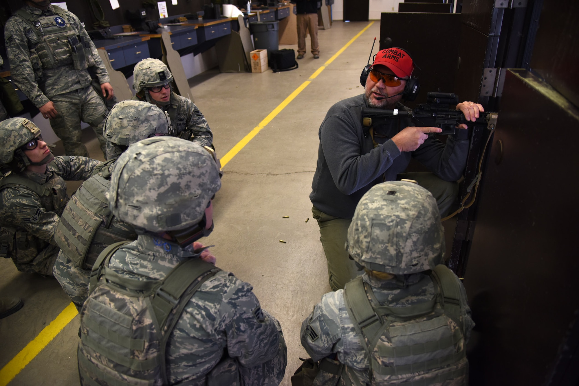 Jim Maloney, 341st Security Support Squadron Combat Arms instructor, teaches security forces members from Malmstrom Air Force Base proper firing techniques during their annual qualification training at the Combat Arms Training and Maintenance shooting range Oct. 30. On an annual basis, the CATM range trains more than 5,500 military personnel. (U.S. Air Force photo/ Airman 1st Class Joshua Smoot)