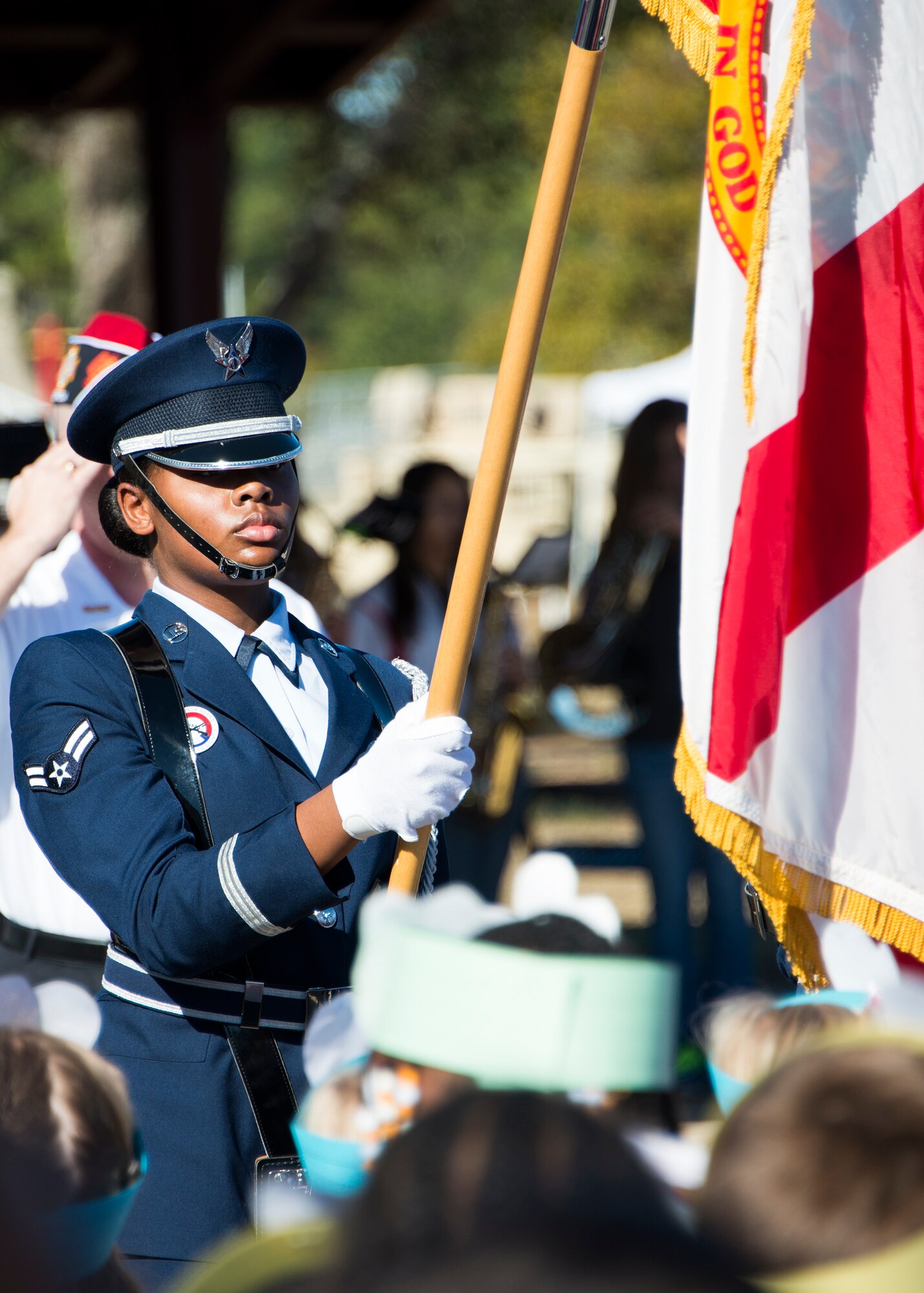 An Eglin Air Force Base honor guard Airman presents the colors during a Veteran’s Day celebration held at Riverside Elementary in Crestview, Fla., Nov. 10.  Airmen from explosive ordnance disposal, life support, honor guard and 6th Ranger Training Battalion Soldiers were on hand to interact with the children in this first-ever school event.  (U.S. Air Force photo/Tech. Sgt. Jasmin Taylor)