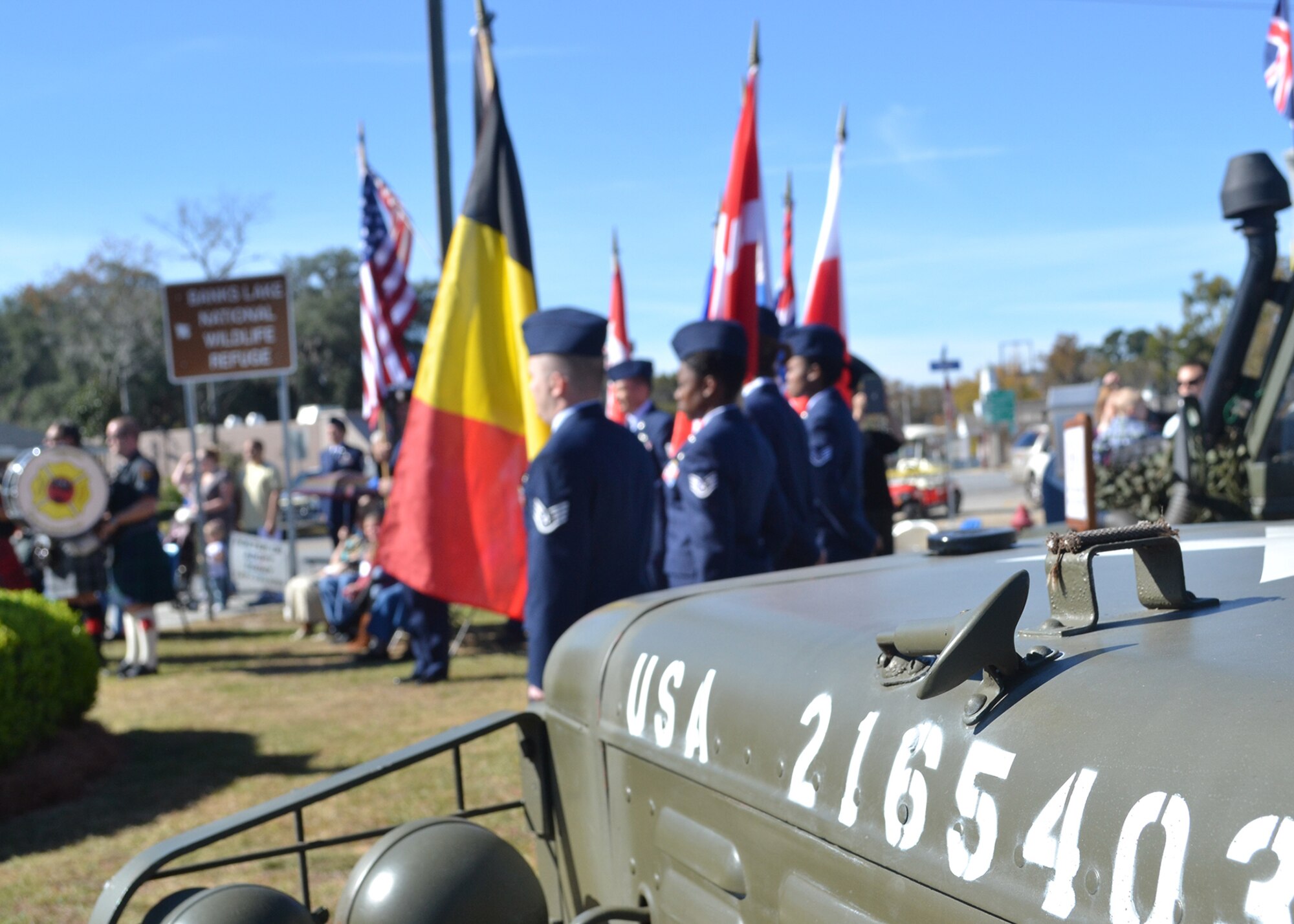 Moody Airmen hold flags from various nations during a Veterans Day ceremony Nov. 11, 2014, in Lakeland, Ga.  Historic military vehicles served as a backdrop for the event at the town’s war memorial near the Lanier county courthouse. (U.S. Air Force photo by Master Sgt. Sonny Cohrs/Released)