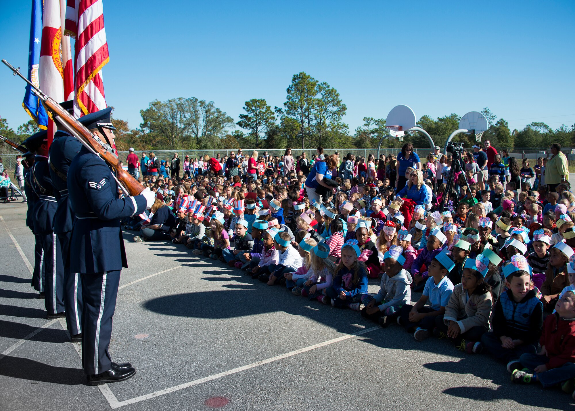 The Eglin Air Force Base honor guard presents the colors during a Veteran’s Day celebration held at Riverside Elementary in Crestview, Fla., Nov. 10.  Airmen from explosive ordnance disposal, life support, honor guard and 6th Ranger Training Battalion Soldiers were on hand to interact with the children in this first-ever school event.  (U.S. Air Force photo/Tech. Sgt. Jasmin Taylor)