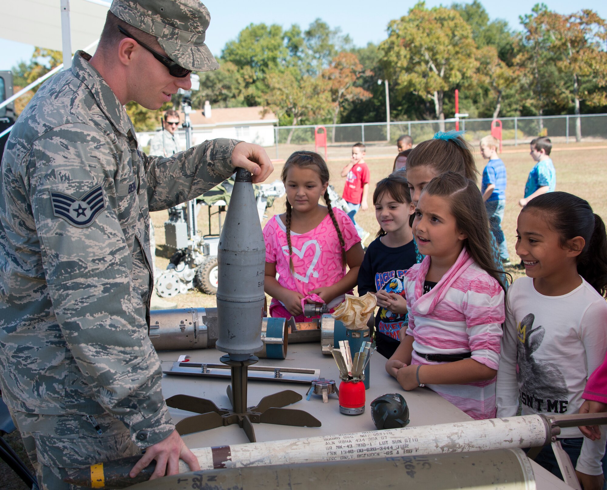 Staff Sgt. Chad Bennett, 96th Explosive Ordnance Disposal flight, talks to the kids of Riverside Elementary about his job during a Veteran’s Day celebration held at the school in Crestview, Fla., Nov. 10.  Local veterans, Airmen from explosive ordnance disposal, life support, honor guard and 6th RTB Soldiers were on hand to interact with the children in this first-ever school event.  (U.S. Air Force photo/Tech. Sgt. Jasmin Taylor)