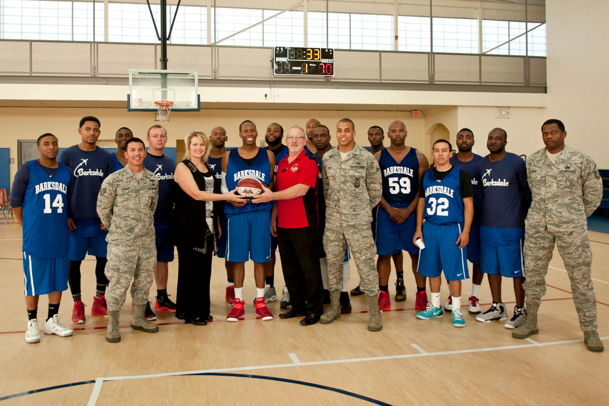 Debra Green, the General Manager and Director of Marketing, and Gary Green, the Director of Operations, from the Shreveport-Bossier Mavericks, present a signed game ball to the Barksdale All-Star Basketball Team at Barksdale Air Force Base, LA, Nov. 1, 2014. The Mavericks, part of the American Basketball Association, played an exhibition game against the Barksdale All-Stars in preparation for their 2014-2015 professional season. (U.S. Air Force photo by Master Sgt. Dachelle Melville/Released)