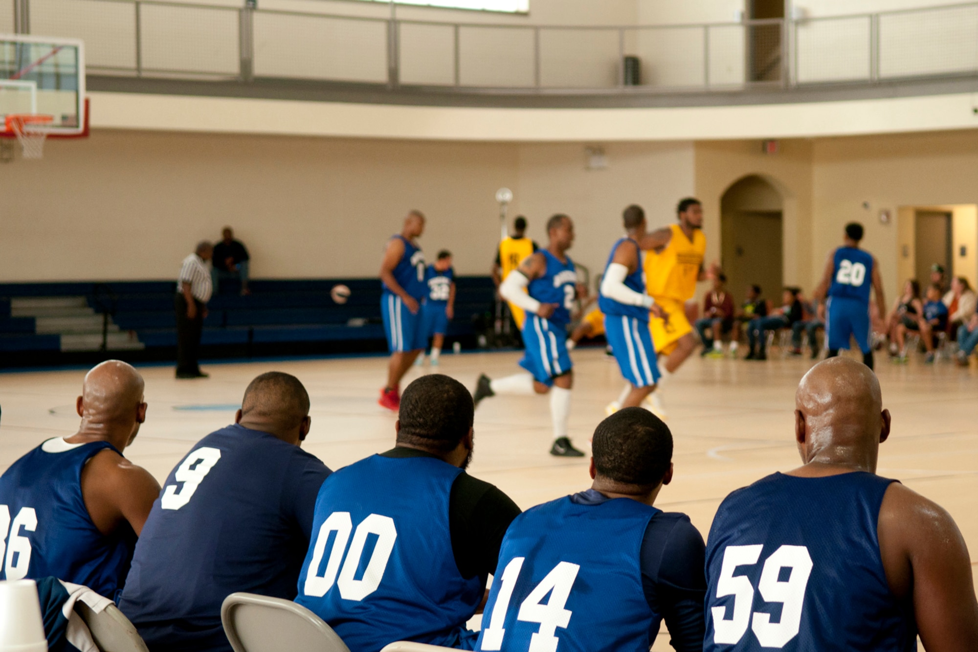 The Barksdale All-Stars Basketball Team play an exhibition game against the Shreveport-Bossier Mavericks while their teammates watch from the sidelines at the Senior Airman Bryan R. Bell Fitness Center, Barksdale Air Force Base, La., Nov. 1, 2014. The American Basketball Association team visited Barksdale Air Force Base before beginning their 2014-2015 professional season. (U.S. Air Force photo by Master Sgt. Dachelle Melville/Released)