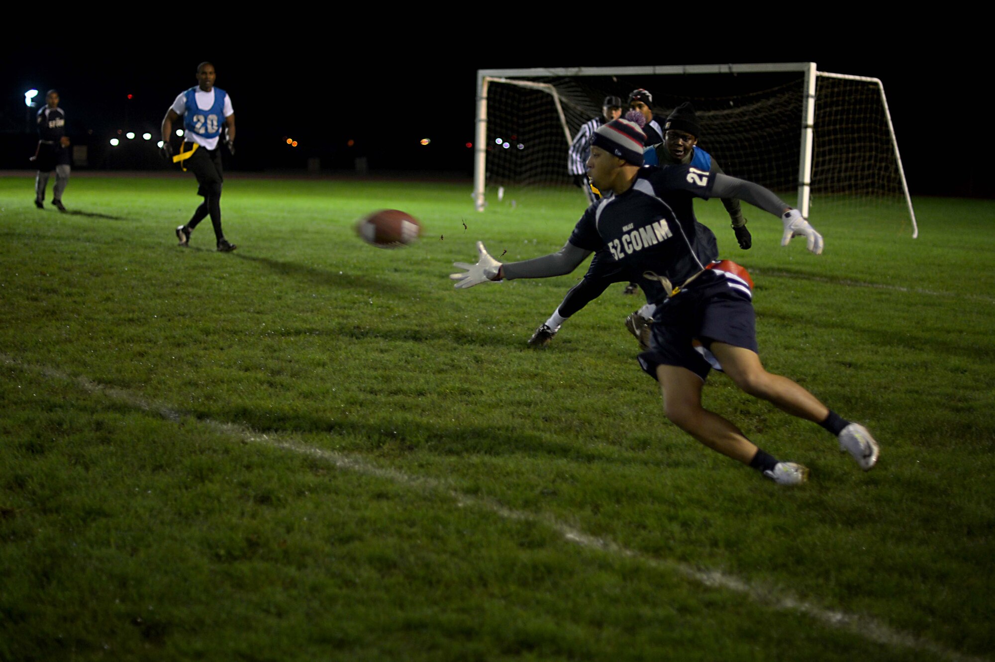 A U.S. Air Force Airman from the 52nd Communications Squadron attempts to catch a football during the intramural football game at Spangdahlem Air Base, Germany, Nov. 10, 2014. The 52nd CS ended the hopes of a victory for the 52nd Civil Engineer Squadron with a final score of 20 to 19. (U.S. Air Force photo by Airman 1st Class Kyle Gese/Released)