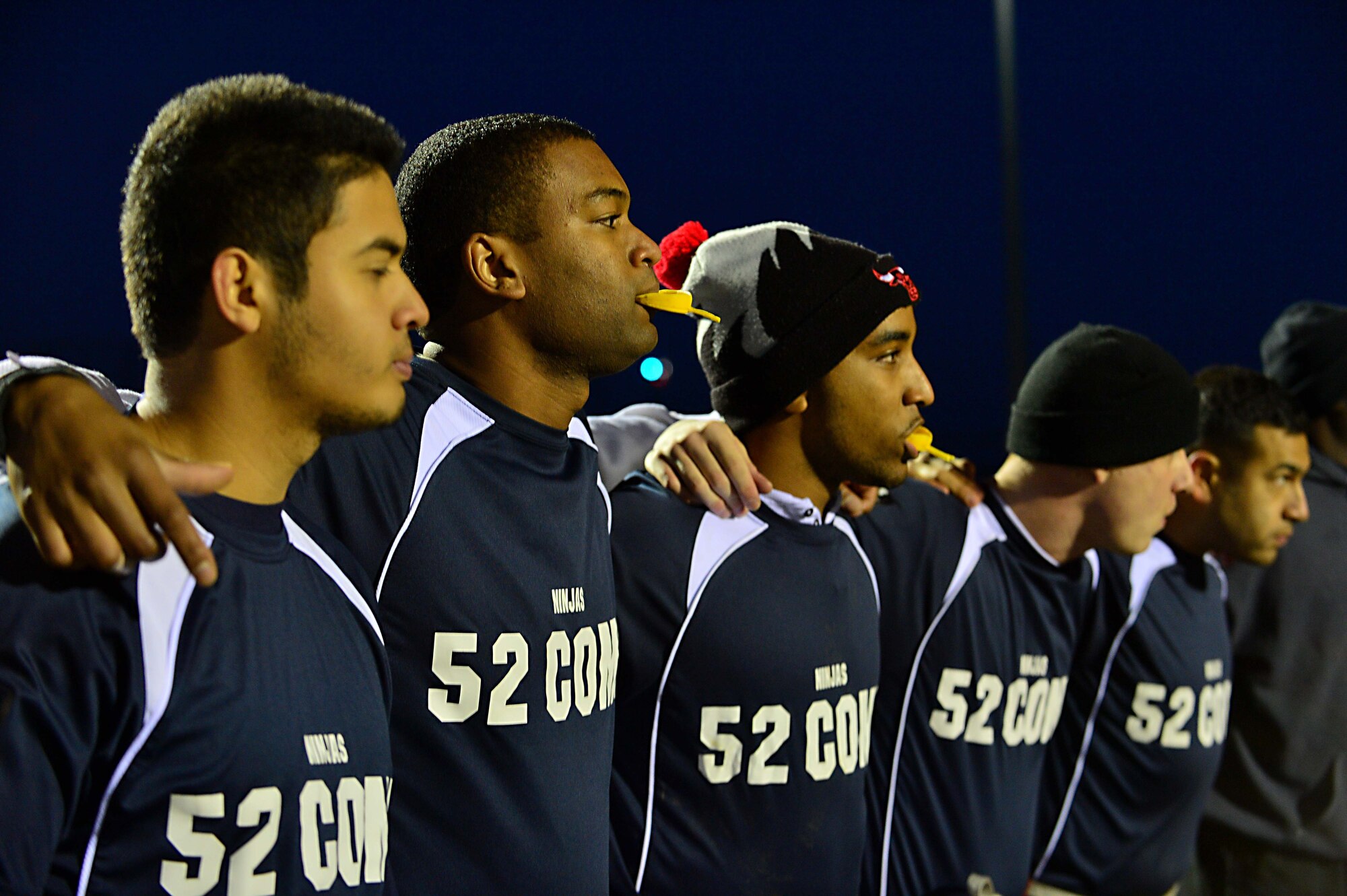U.S. Air Force Airmen from the 52nd Communications Squadron football team meet before the intramural football game at Spangdahlem Air Base, Germany, Nov. 10, 2014. Airmen from the 52nd CS and the 52nd Civil Engineer Squadron played against one another for the championship title. (U.S. Air Force photo by Airman 1st Class Kyle Gese/Released)