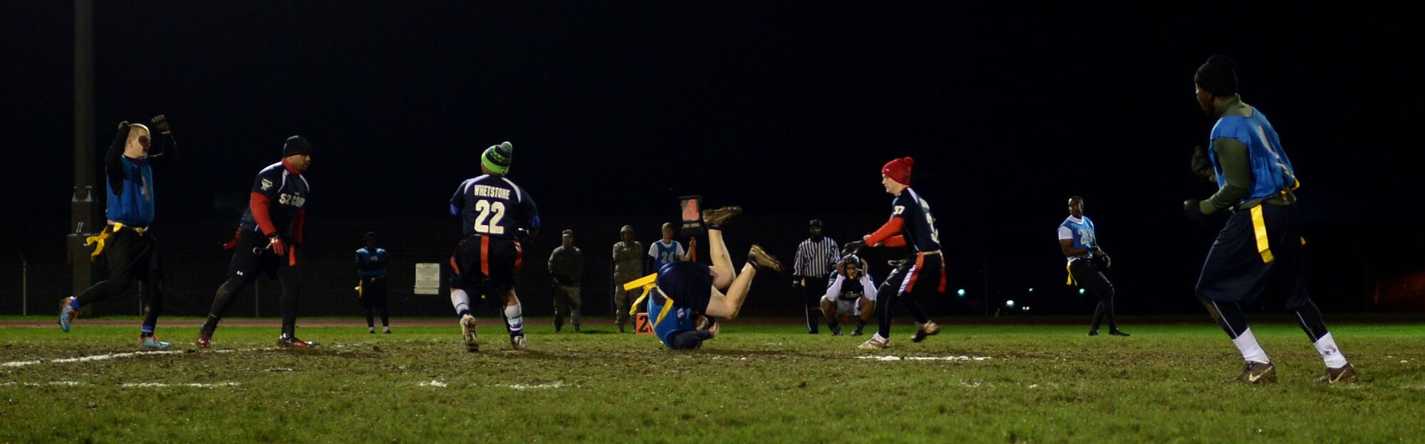 An Airman from the 52nd Civil Engineer Squadron catches a football during the intramural football championship game at Spangdahlem Air Base, Germany, Nov. 10, 2014. The 52nd CES were neck and neck with the 52nd Communications Squadron until failing a two-point conversion in overtime, ending with a score of 19 to 20. (U.S. Air Force photo by Staff Sgt. Daryl Knee/Released)
