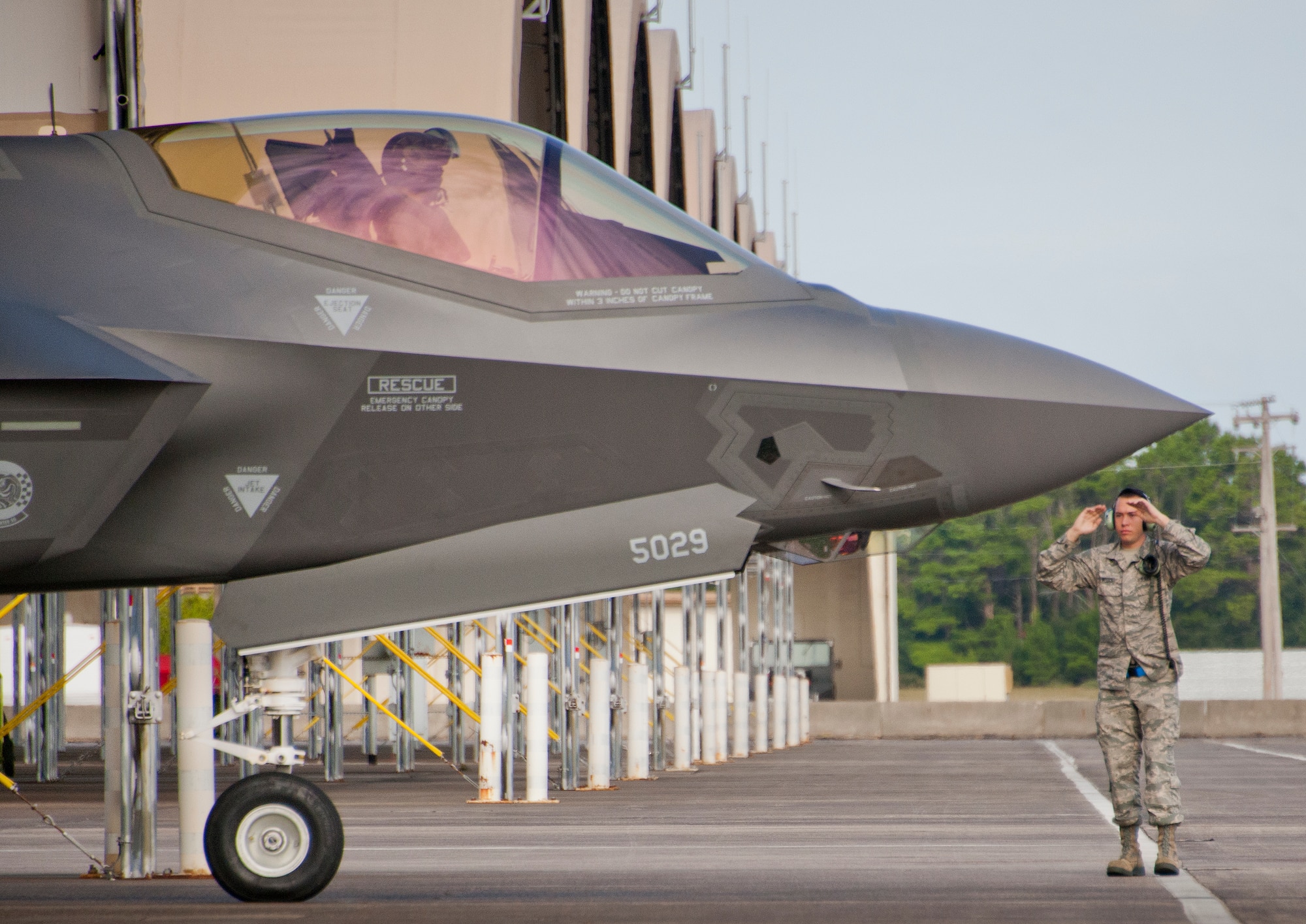 A 33rd Maintenance Group Airman marshals out an F-35A Lightning II for a sortie at Eglin Air Force Base, Fla.  The 33rd Maintenance Group is responsible for the maintenance of the Air Force’s joint strike fighter fleet on base.  (U.S. Air Force photo/Samuel King Jr.)