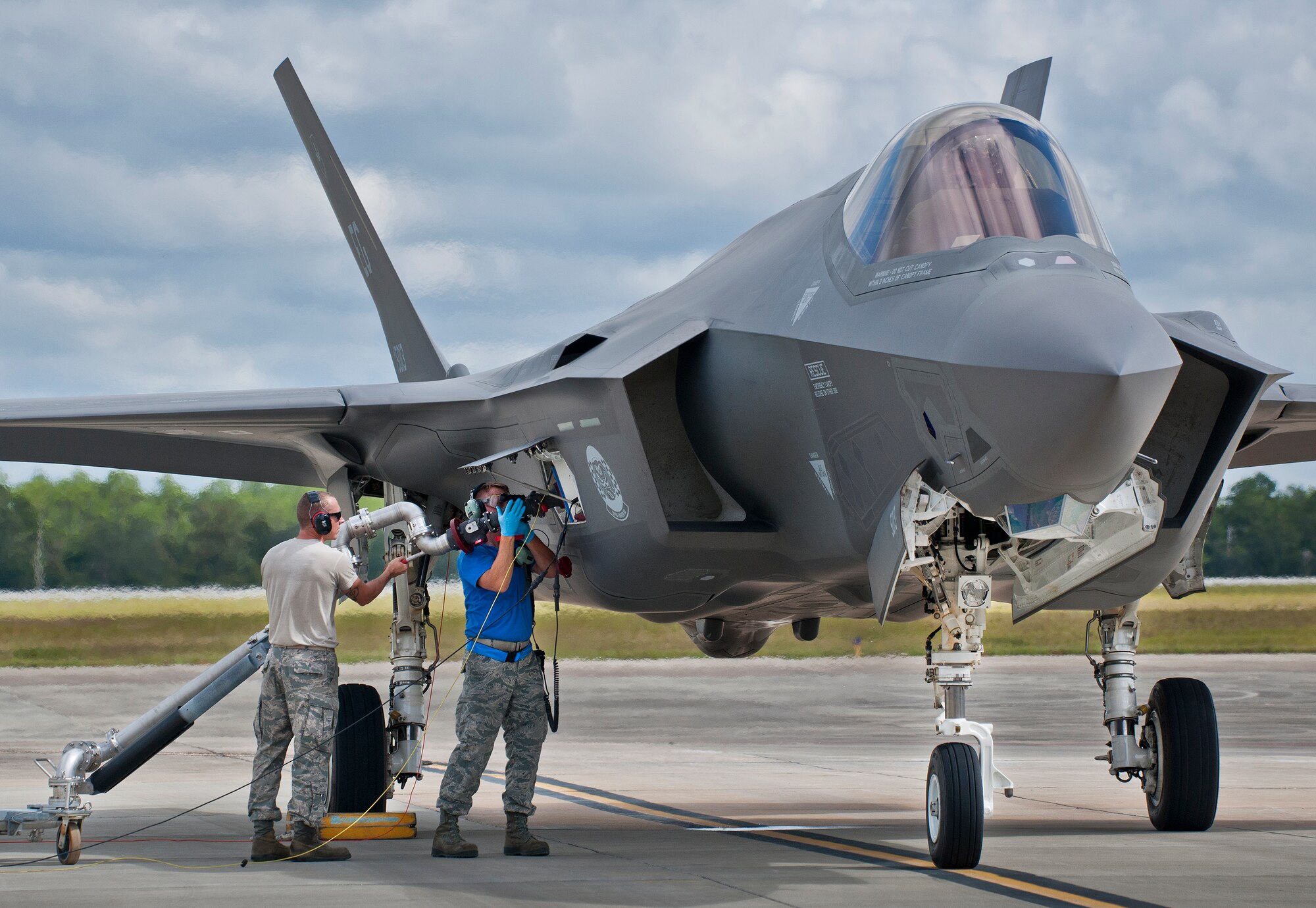 Staff Sgt. Jason Schuler, 33rd Aircraft Maintenance Squadron, connects the fuel nozzle to an F-35A Lightning II during a hot pit session at Eglin Air Force Base, Fla.  All of the F-35 variants use the refueling areas in conjunction with the 96th Logistics Readiness Squadron’s fuels flight. (U.S. Air Force photo/Samuel King Jr.)