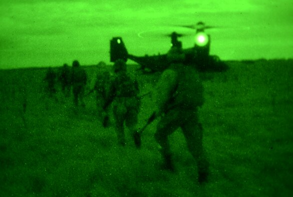U.S. Air Force Air Commandos from the 321st Special Tactics Squadron, along with host nation partners, exfilrate to a waiting CV-22B from the 7th Special Operations Squadron Nov. 6, 2014, during a training mission at RAF Sculthorpe in Norwich, England. During the mission, Air Commandos searched for simulated potential threats and rescued simulated hostages in the training area. (U.S. Air Force photo by Airman 1st Class Dillon Johnston/Released)