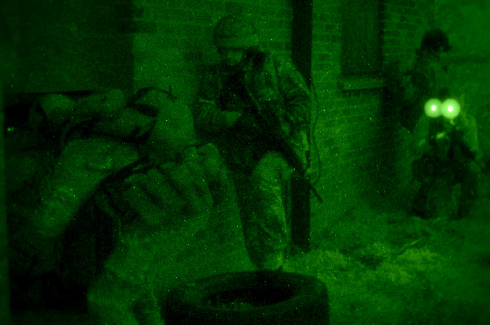 U.S. Air Force Air Commandos from the 321st Special Tactics Squadron, along with host nation partners, prepare to clear a building Nov. 6, 2014, during a training mission at RAF Sculthorpe in Norwich, England. During the mission, Air Commandos searched for simulated potential threats and rescued simulated hostages in the training area. (U.S. Air Force photo by Airman 1st Class Dillon Johnston/Released)