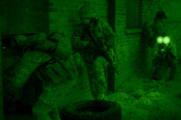 U.S. Air Force Air Commandos from the 321st Special Tactics Squadron, along with host nation partners, prepare to clear a building Nov. 6, 2014, during a training mission at RAF Sculthorpe in Norwich, England. During the mission, Air Commandos searched for simulated potential threats and rescued simulated hostages in the training area. (U.S. Air Force photo by Airman 1st Class Dillon Johnston/Released)